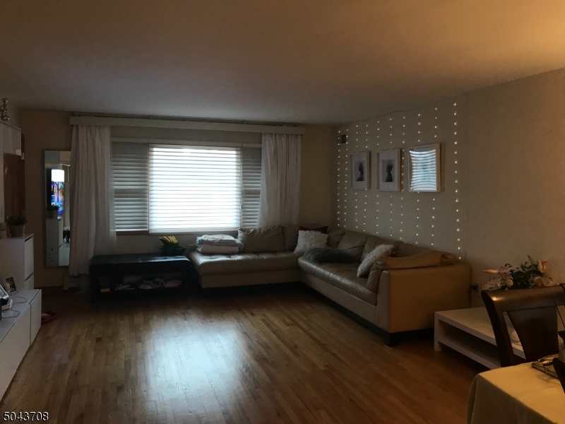 82 Cloverdale Road, Unit 1 Clifton, NJ 07013 - Photo 5 of 12 a living room with furniture and a window