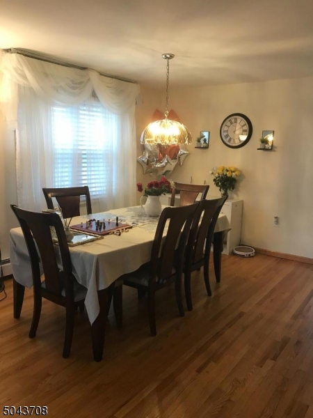 82 Cloverdale Road, Unit 1 Clifton, NJ 07013 - Photo 6 of 12 a view of a dining room with furniture and wooden floor