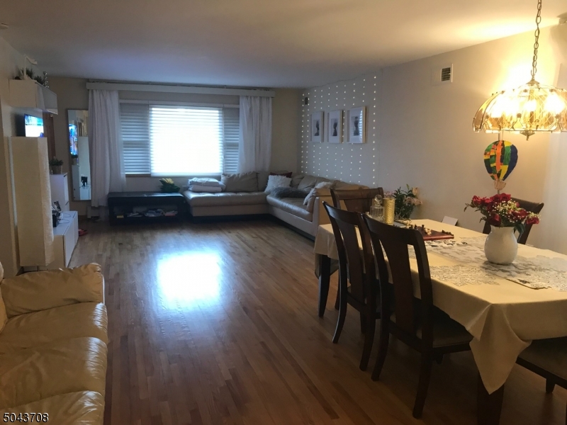 82 Cloverdale Road, Unit 1 Clifton, NJ 07013 - Photo 7 of 12 a view of a dining room with furniture and wooden floor