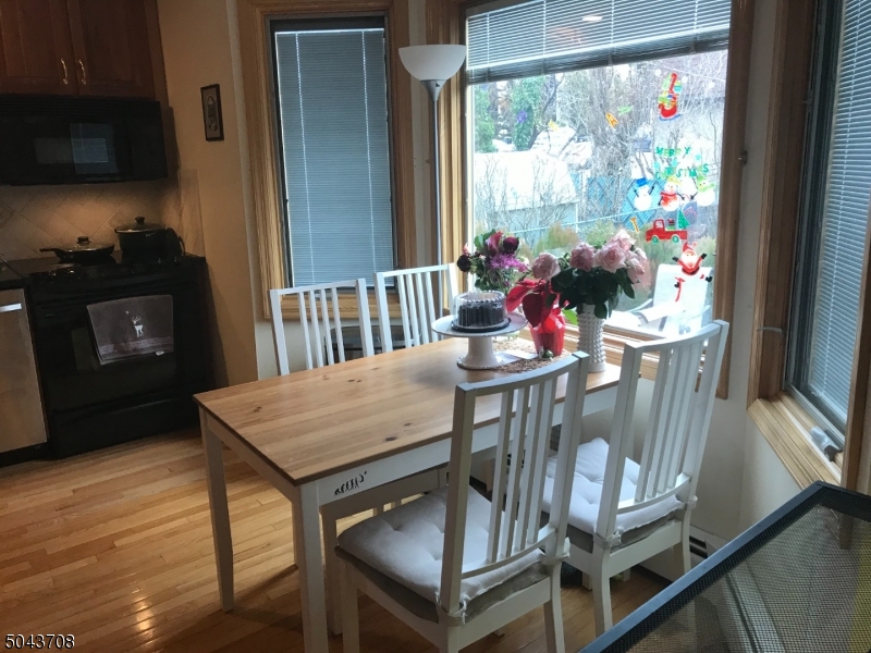 82 Cloverdale Road, Unit 1 Clifton, NJ 07013 - Photo 9 of 12 a view of a dining room with furniture a rug and wooden floor