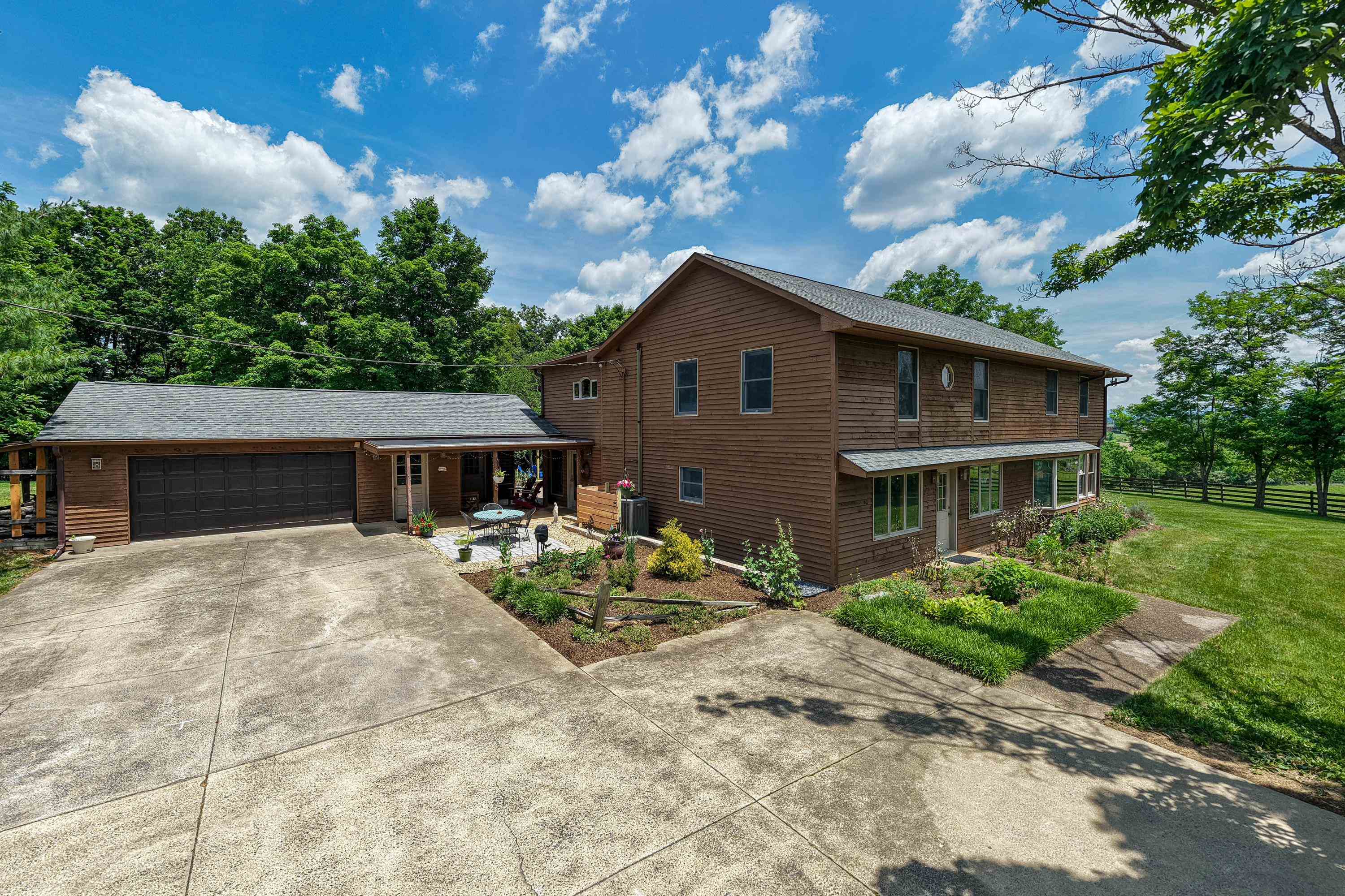 3980 Greenmount Road Harrisonburg, VA 22802 - Photo 2 of 75 The front view highlights the spacious acreage surrounding this lovely home, large front porch, and expansive detached garage. This home also features a large driveway for parking and landscaping.