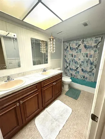 a spacious bathroom with a sink mirror and a bathtub