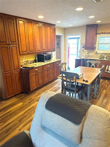 a kitchen with stainless steel appliances granite countertop a stove a sink and a microwave