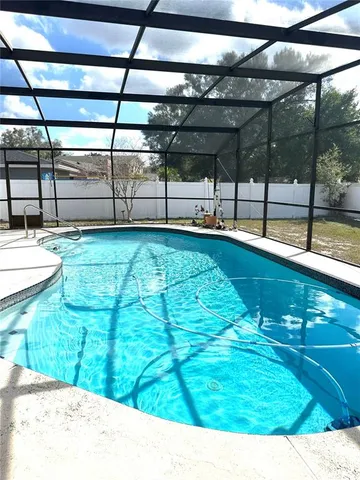 a view of a swimming pool with a yard