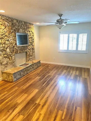 a view of a room with wooden floor and chandelier