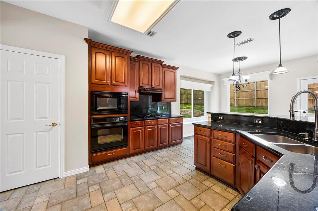 645 Channel Ridge Drive Rockwall, TX 75087 - Photo 11 of 40 Appliances include a gas cooktop, wall oven, microwave and dishwasher.