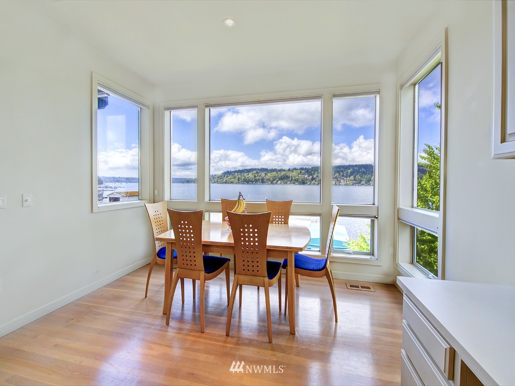 7023 Ripley Lane North Renton, WA 98056 - Photo 3 of 15 a view of a dining room with furniture large windows and wooden floor
