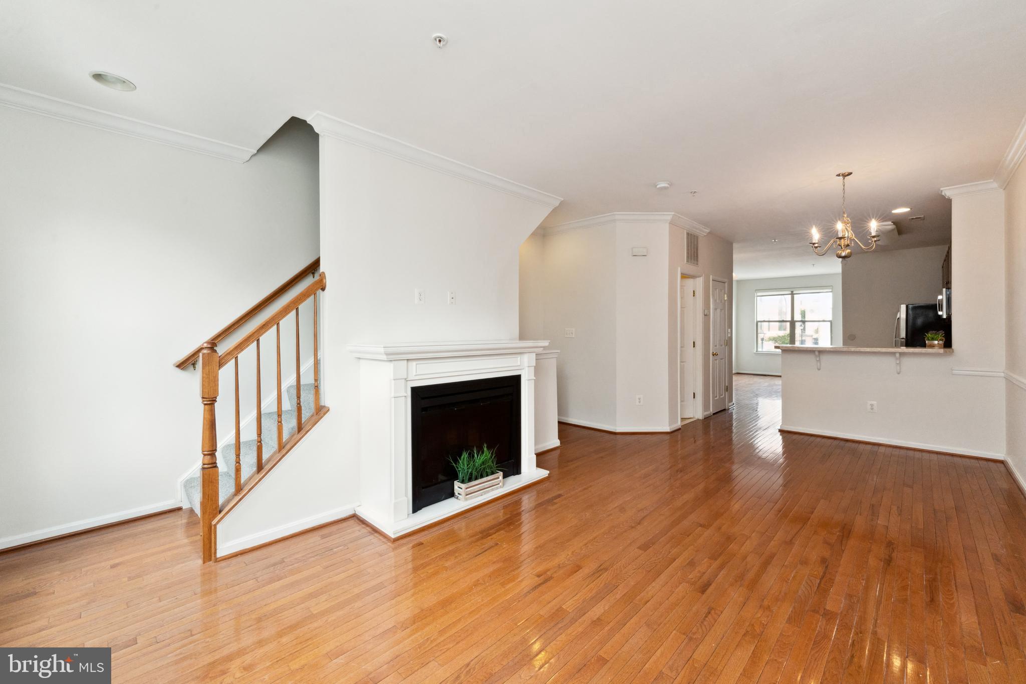 17 South Exeter Street, Unit 161 Baltimore, MD 21202 - Photo 27 of 27 a view of an empty room with wooden floor and a kitchen
