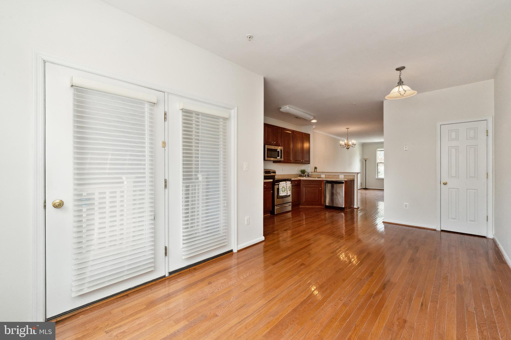 17 South Exeter Street, Unit 161 Baltimore, MD 21202 - Photo 4 of 27 an open kitchen with wooden floor and a kitchen