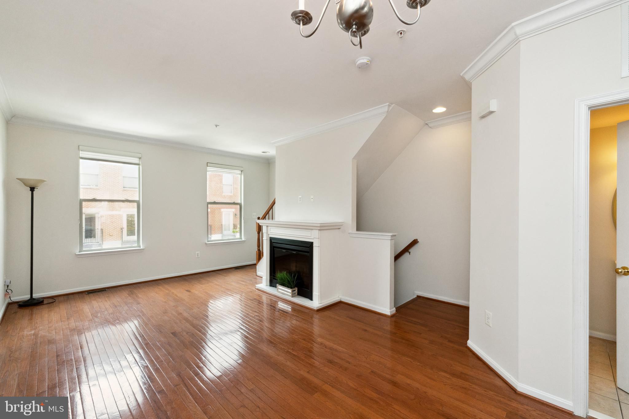 17 South Exeter Street, Unit 161 Baltimore, MD 21202 - Photo 8 of 27 an empty room with wooden floor cabinet and windows