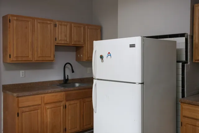 a white refrigerator freezer sitting in a kitchen