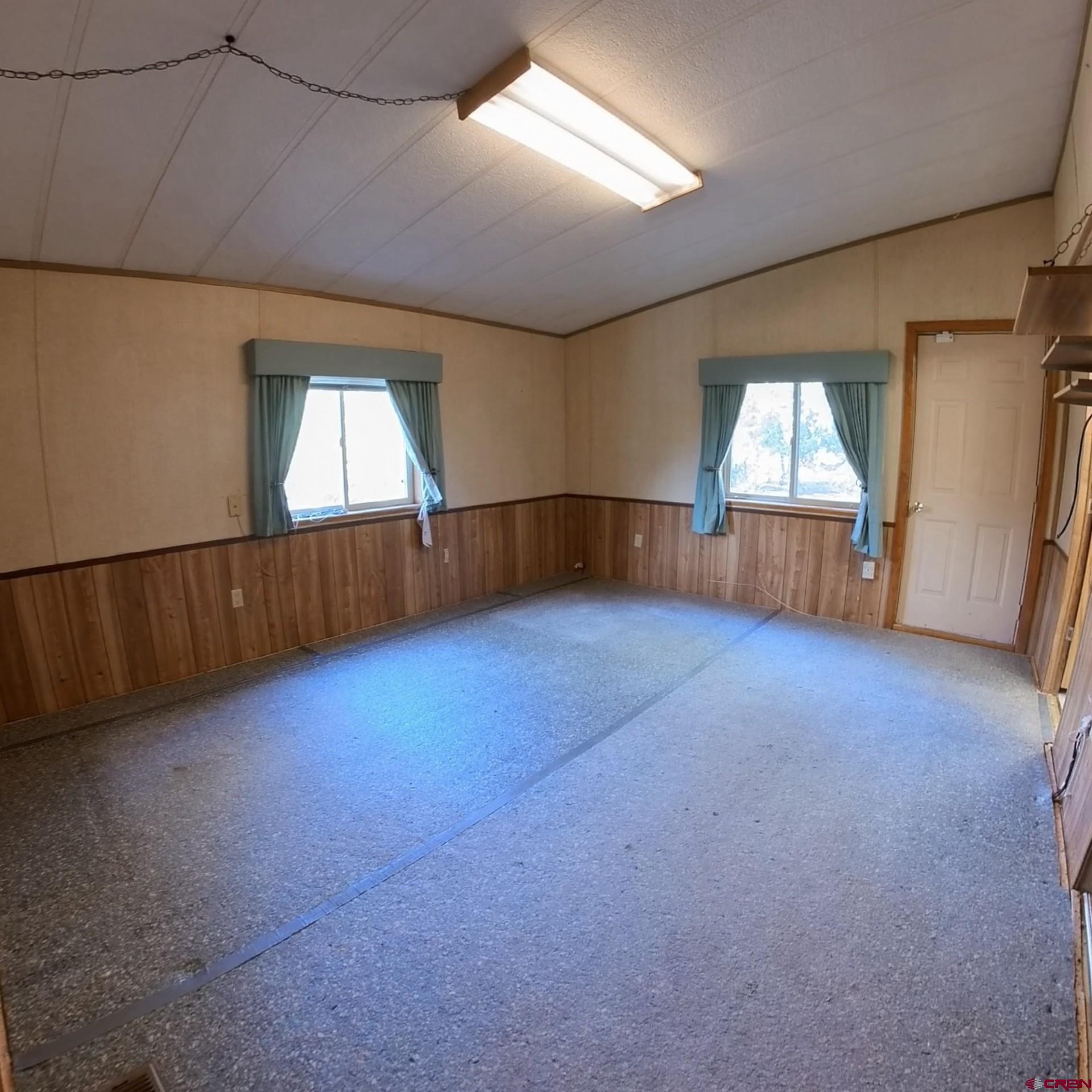 18865 Northridge Road Cedaredge, CO 81413 - Photo 11 of 23 an empty room with windows
