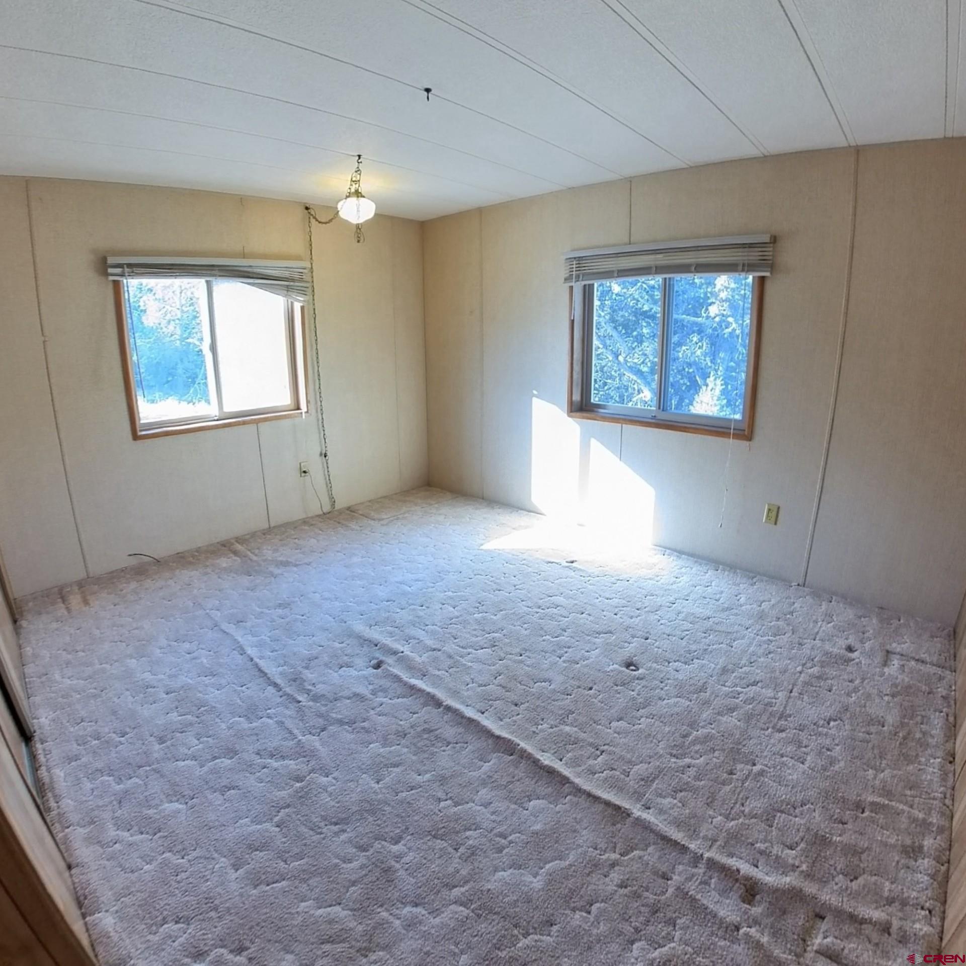 18865 Northridge Road Cedaredge, CO 81413 - Photo 13 of 23 an empty room with windows