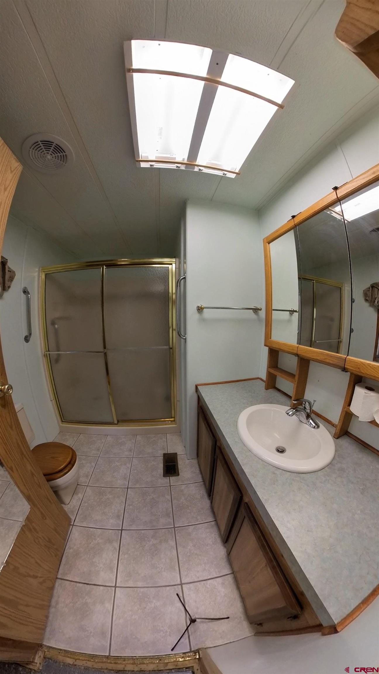 18865 Northridge Road Cedaredge, CO 81413 - Photo 15 of 23 a bathroom with a sink a toilet and mirror