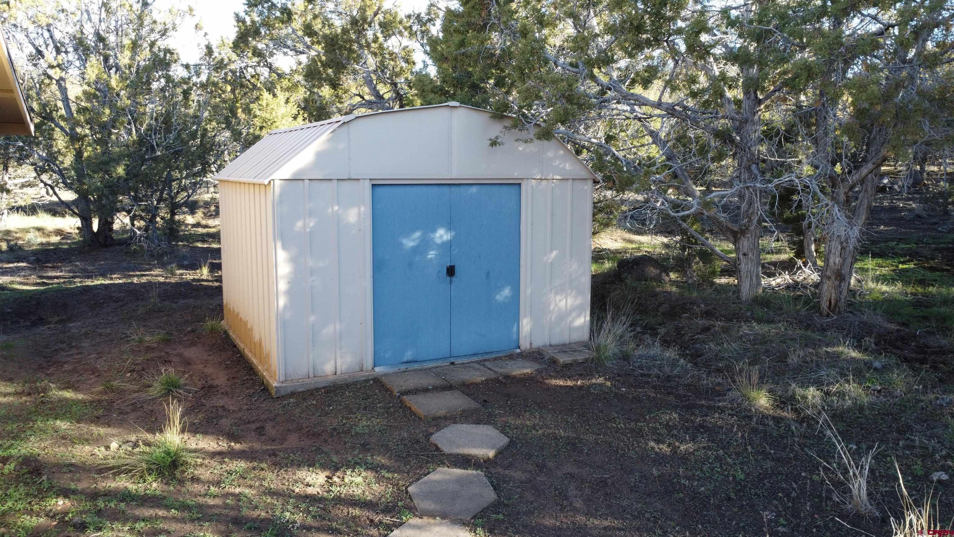 18865 Northridge Road Cedaredge, CO 81413 - Photo 21 of 23 a house with trees in the background