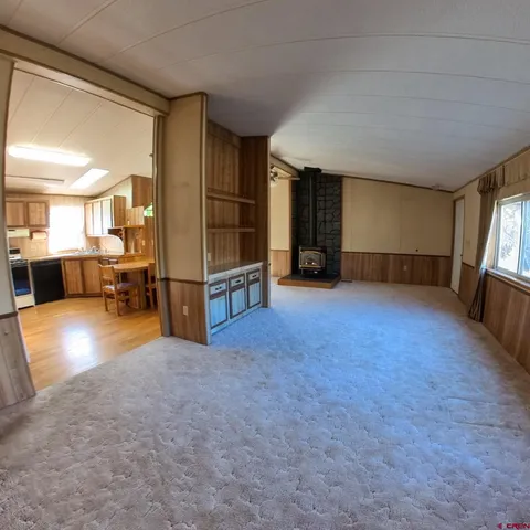 a view of a livingroom with furniture and a window