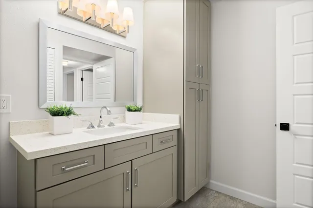 a bathroom with a sink and a mirror