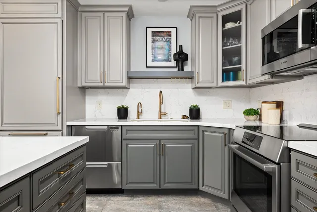 a kitchen with stainless steel appliances granite countertop a sink stove and microwave