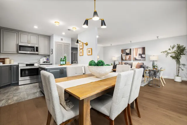 a dining room with furniture and wooden floor