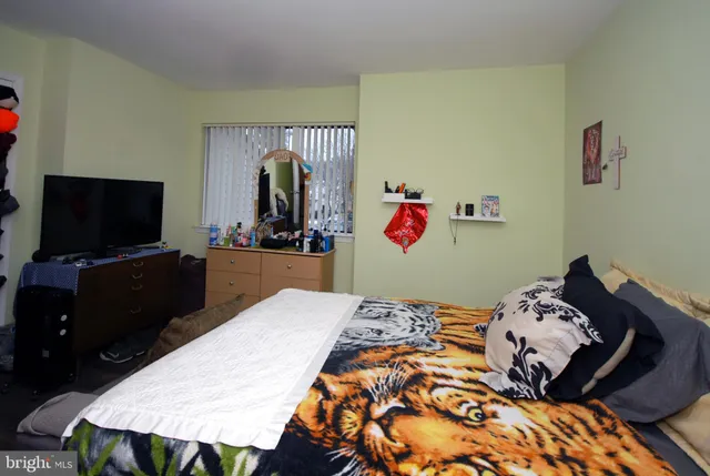 a bed room with a bed window and a chair