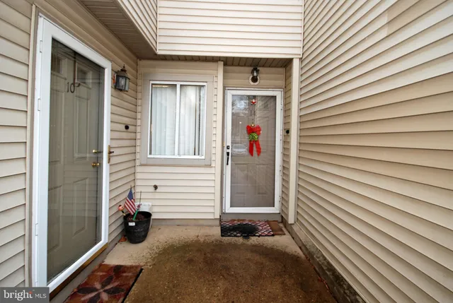 a view of a house with a patio and a yard