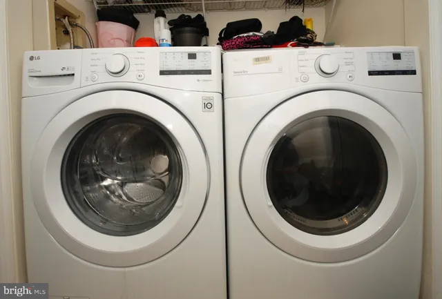 a view of walk in closet with clothes