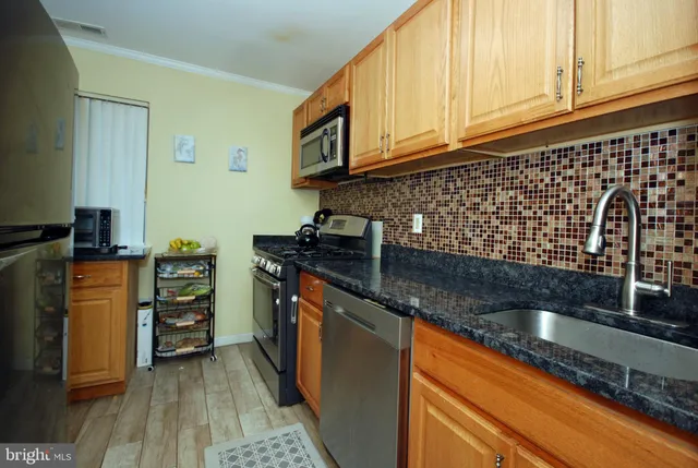 a kitchen with granite countertop a sink and cabinets