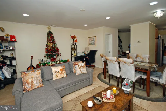 a living room with furniture and a dining table