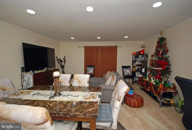 a living room with furniture a flat screen tv and a large window