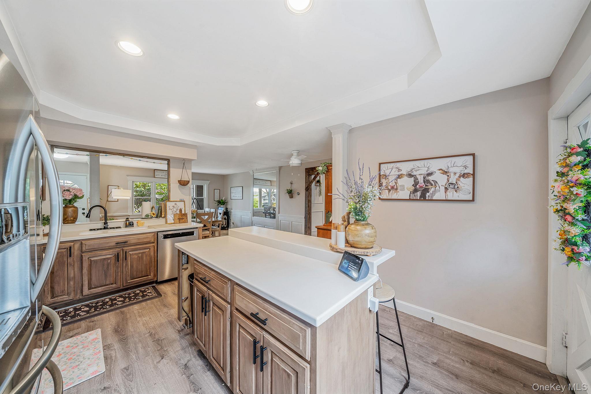 23 Wylde Road Mount Sinai, NY 11766 - Photo 12 of 45 a kitchen with a sink a stove cabinets dining table and chairs