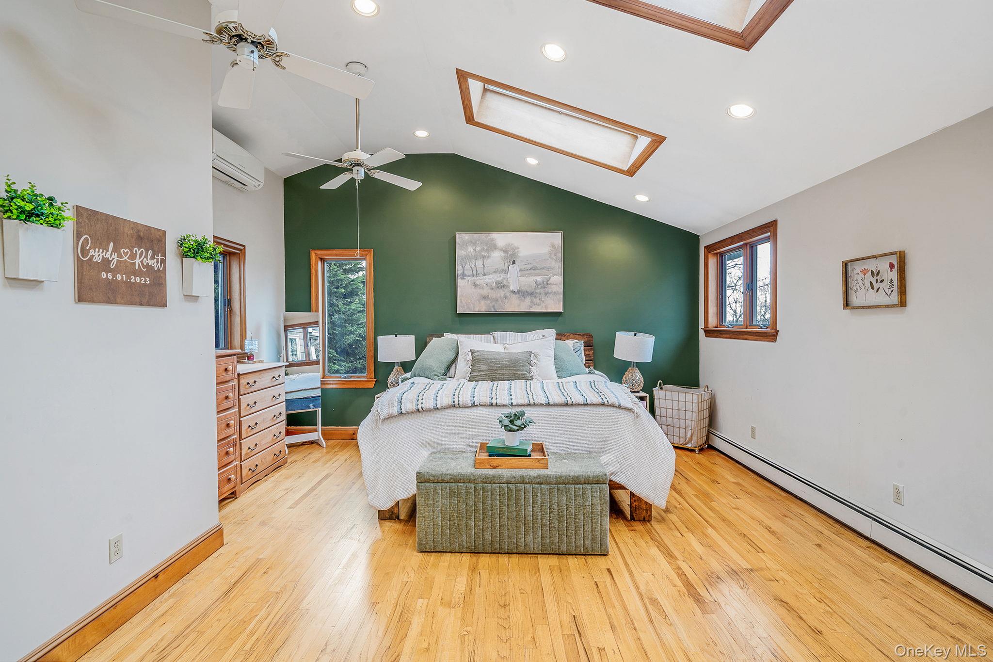 23 Wylde Road Mount Sinai, NY 11766 - Photo 21 of 45 a bed room with a bed and a chandelier