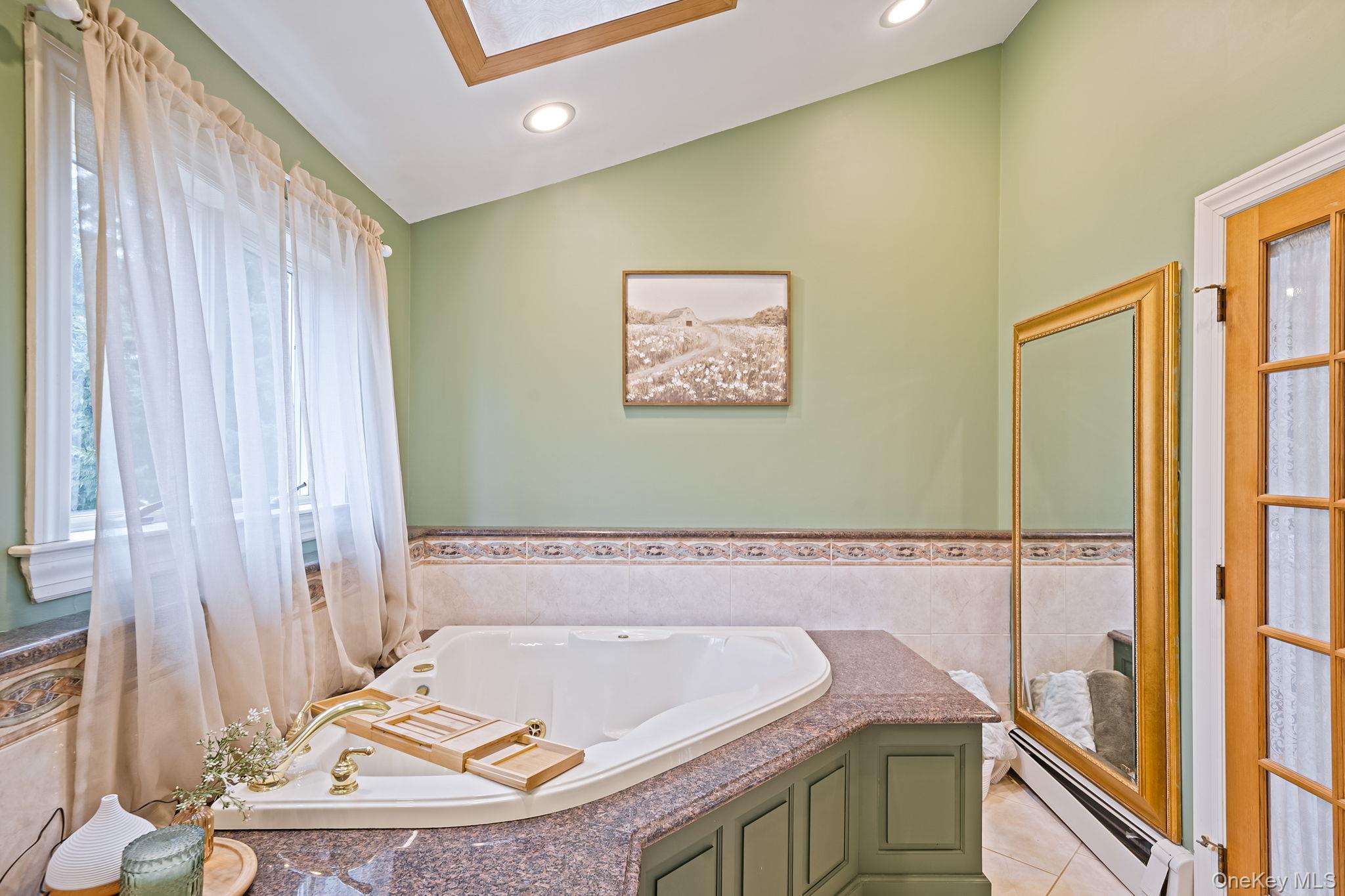 23 Wylde Road Mount Sinai, NY 11766 - Photo 24 of 45 a bath room with a sink and a bath tub