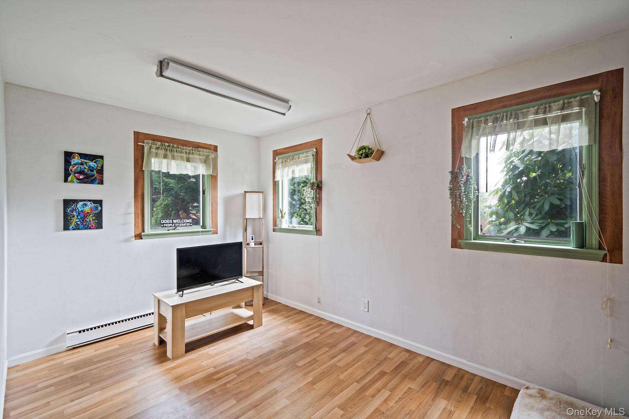 23 Wylde Road Mount Sinai, NY 11766 - Photo 28 of 45 a living room with furniture and a window