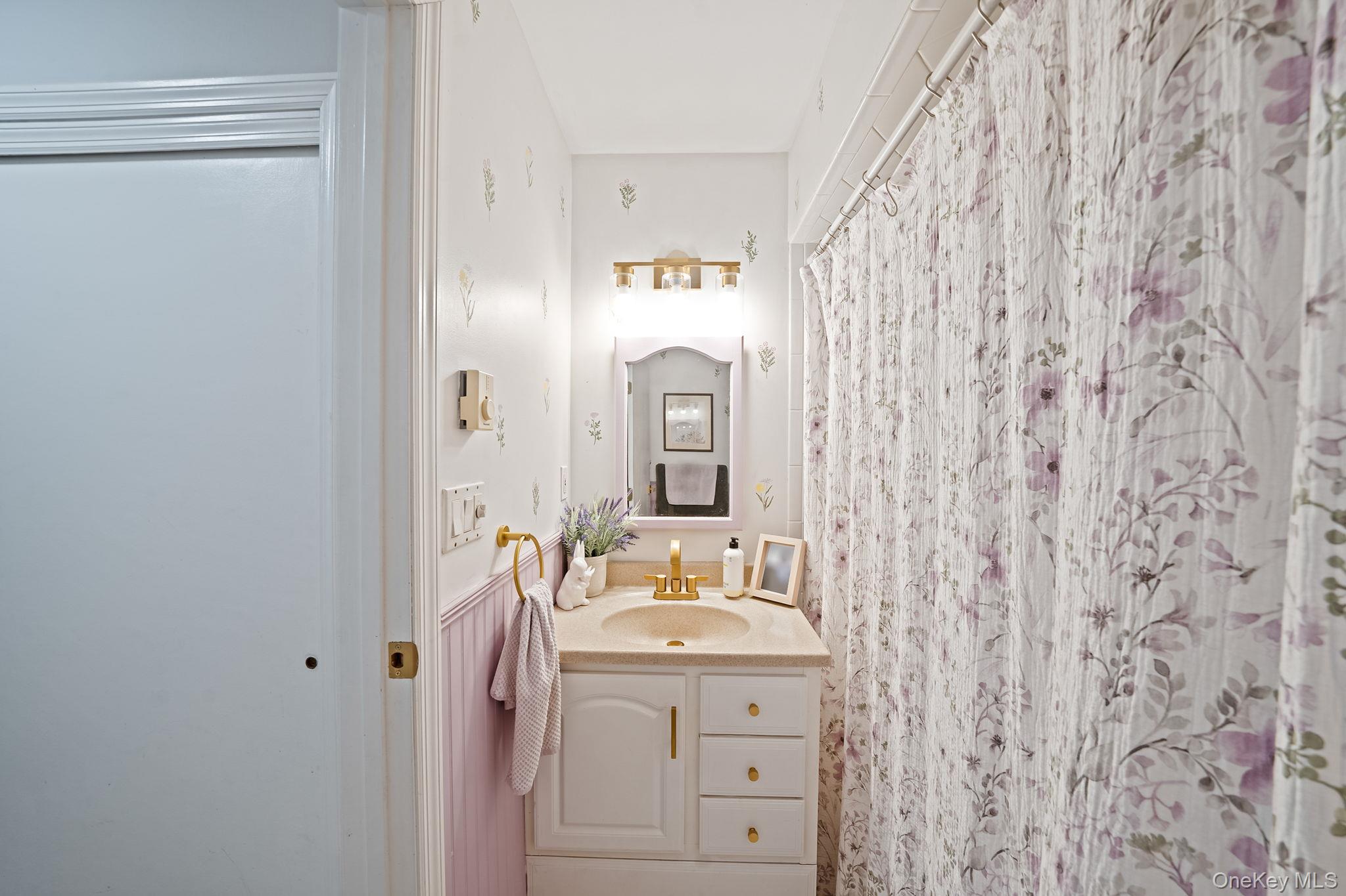 23 Wylde Road Mount Sinai, NY 11766 - Photo 30 of 45 a bathroom with a sink and a mirror