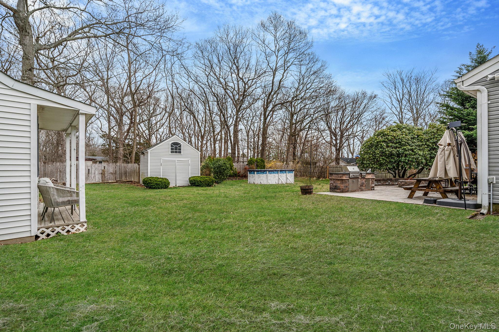 23 Wylde Road Mount Sinai, NY 11766 - Photo 38 of 45 a view of a white house with a big yard and large trees