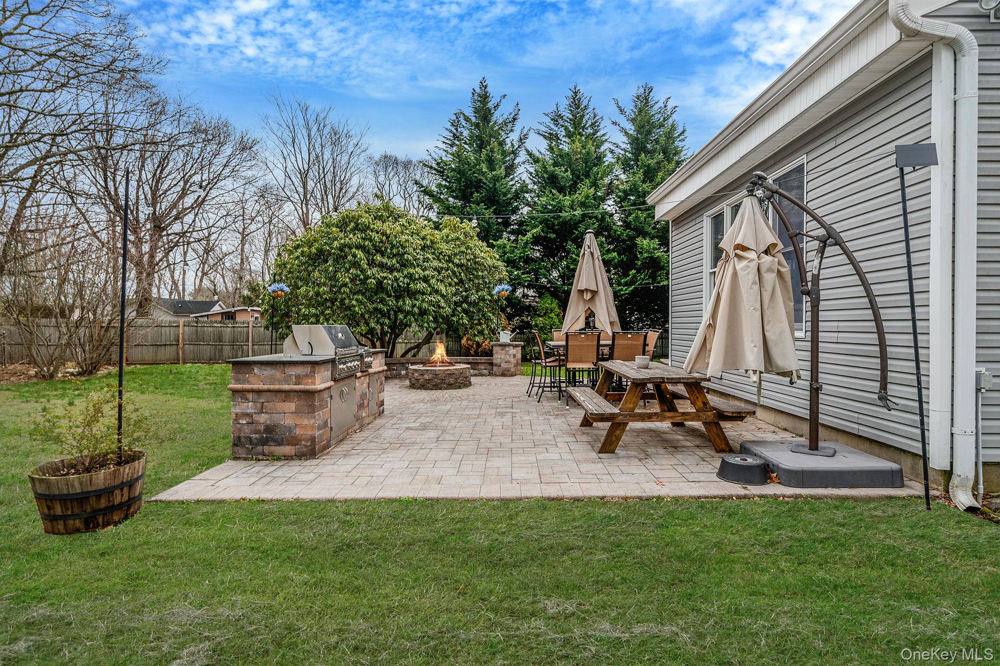 23 Wylde Road Mount Sinai, NY 11766 - Photo 39 of 45 a view of a backyard with sitting area and tree s