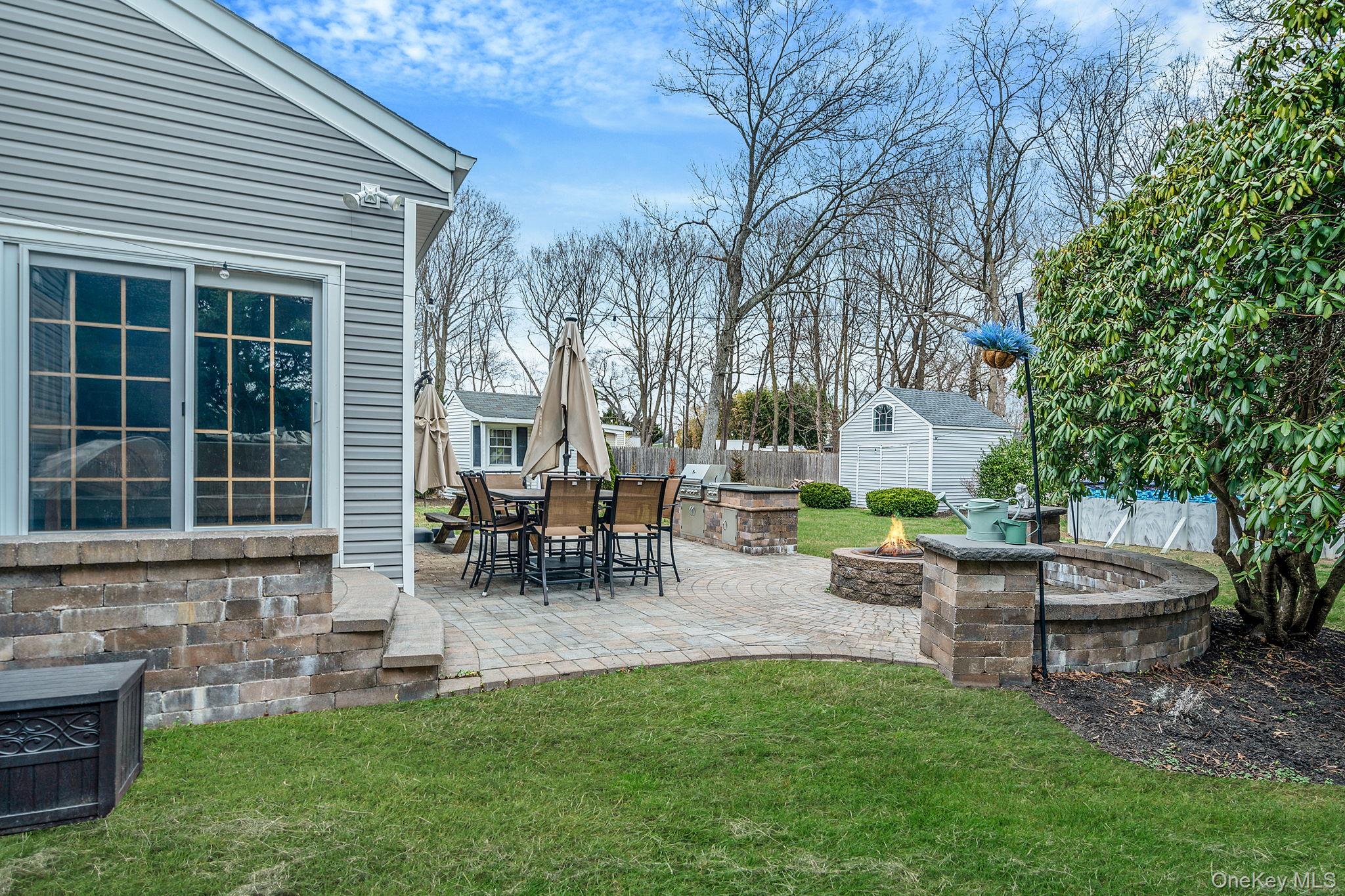 23 Wylde Road Mount Sinai, NY 11766 - Photo 41 of 45 a view of backyard of house with outdoor seating and green space