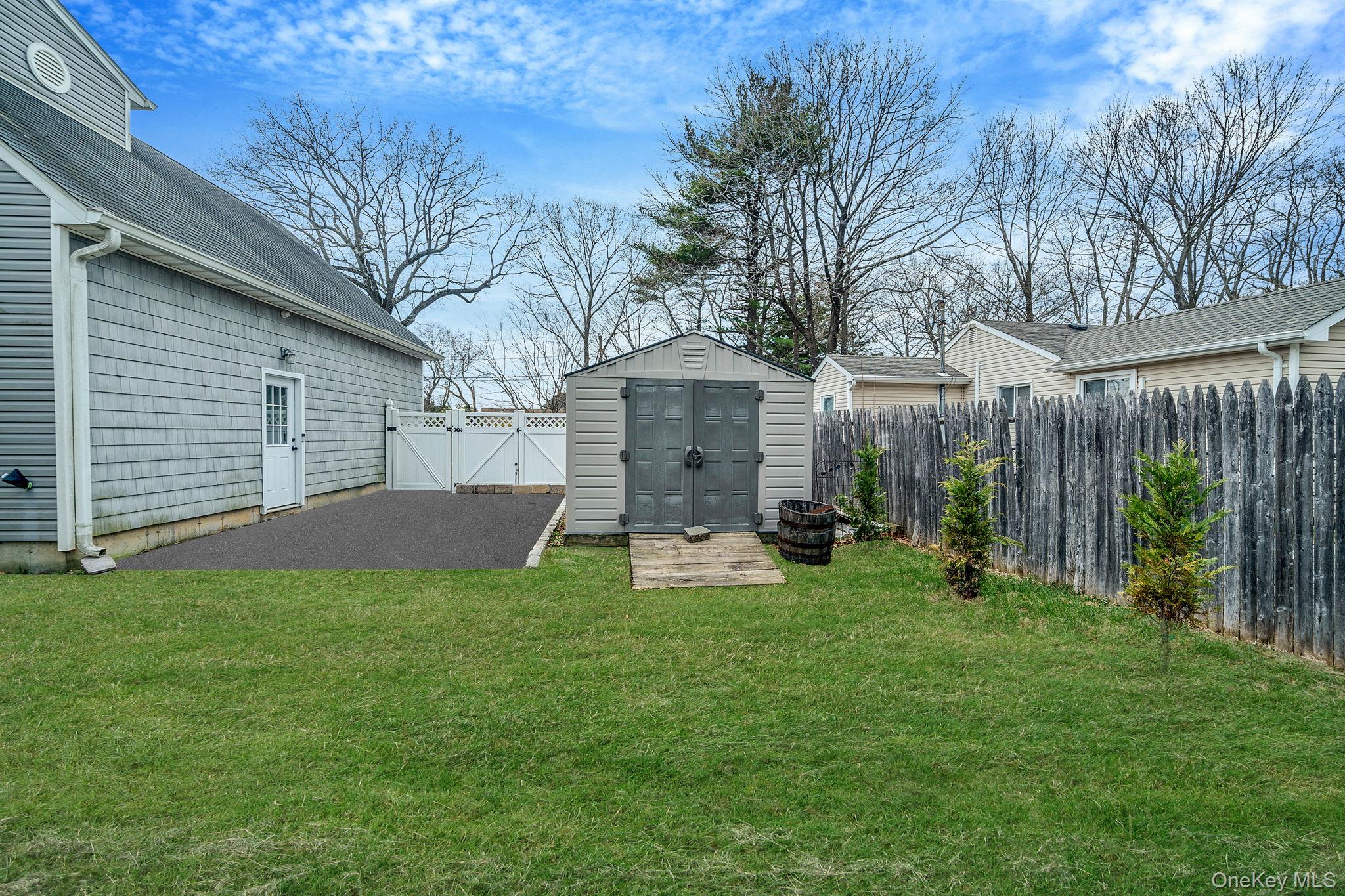 23 Wylde Road Mount Sinai, NY 11766 - Photo 44 of 45 a view of a house with backyard and a tree