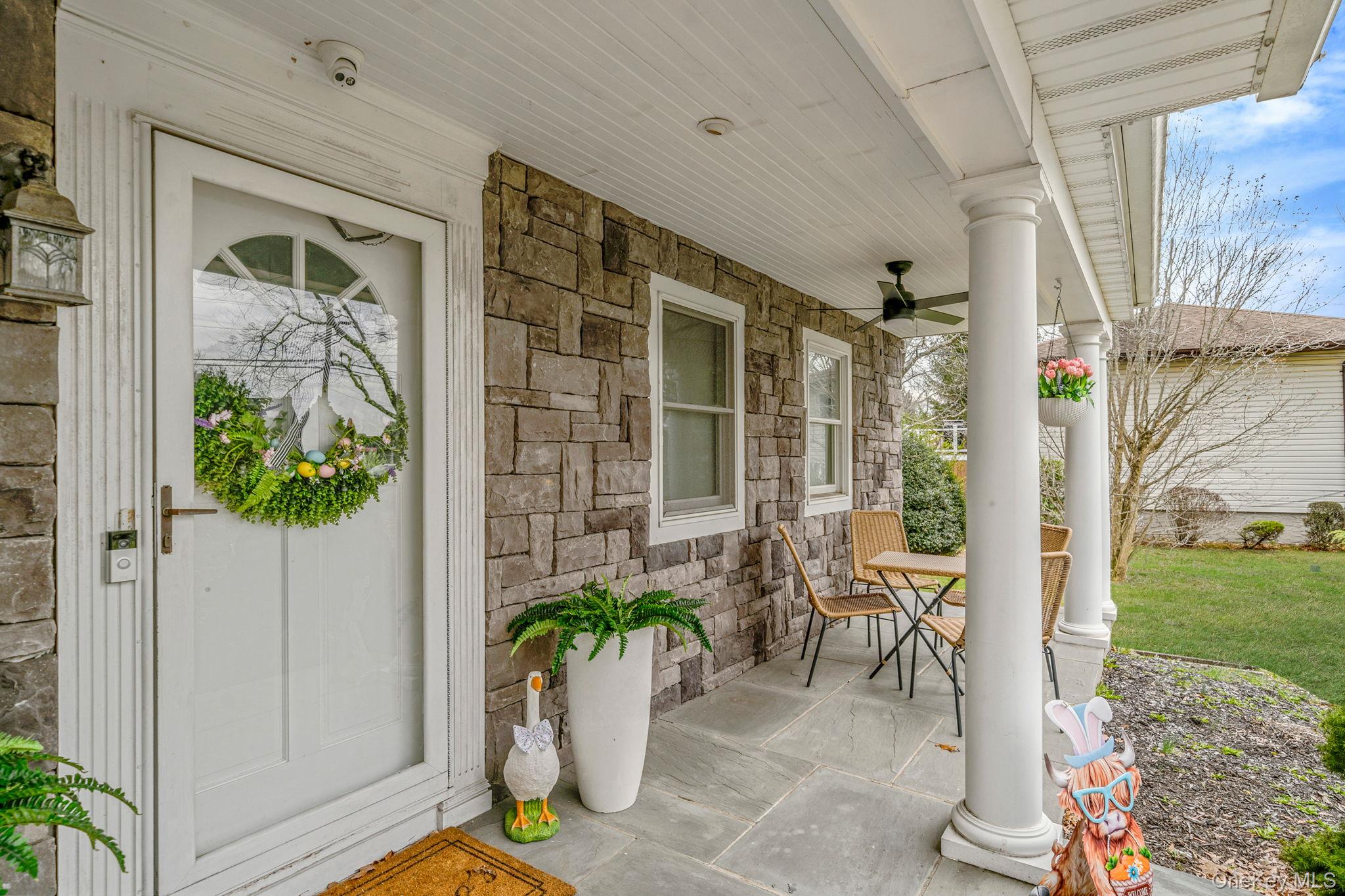 23 Wylde Road Mount Sinai, NY 11766 - Photo 5 of 45 a potted plant sitting in front of a door