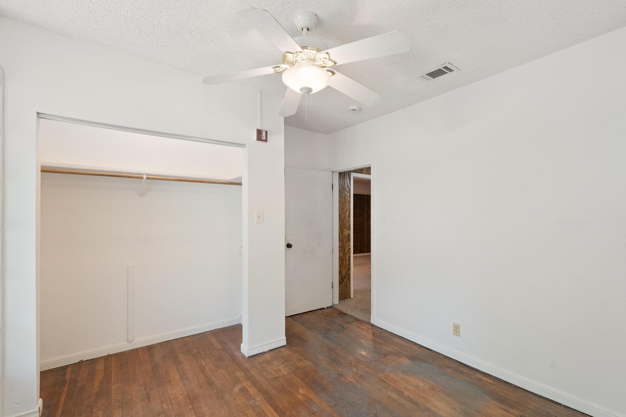 4616 East Cesar Chavez Street Austin, TX 78702 - Photo 22 of 22 an empty room with wooden floor and a ceiling fan