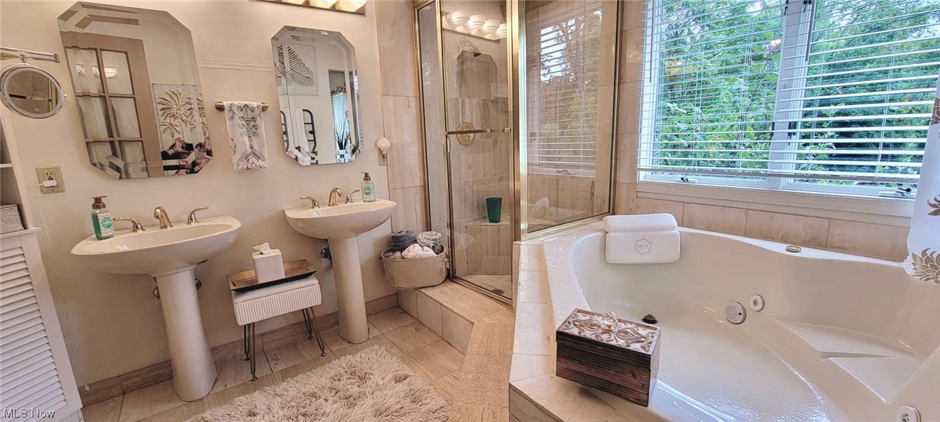 7262 Stone Road Independence, OH 44131 - Photo 28 of 34 Master Bathroom with washbasin, mirror, shower with separate bathtub, and light tile floors
