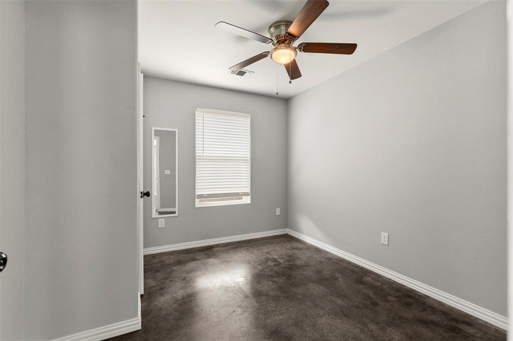 933 Rice Street Denison, TX 75020 - Photo 11 of 19 an empty room with a window and a fan
