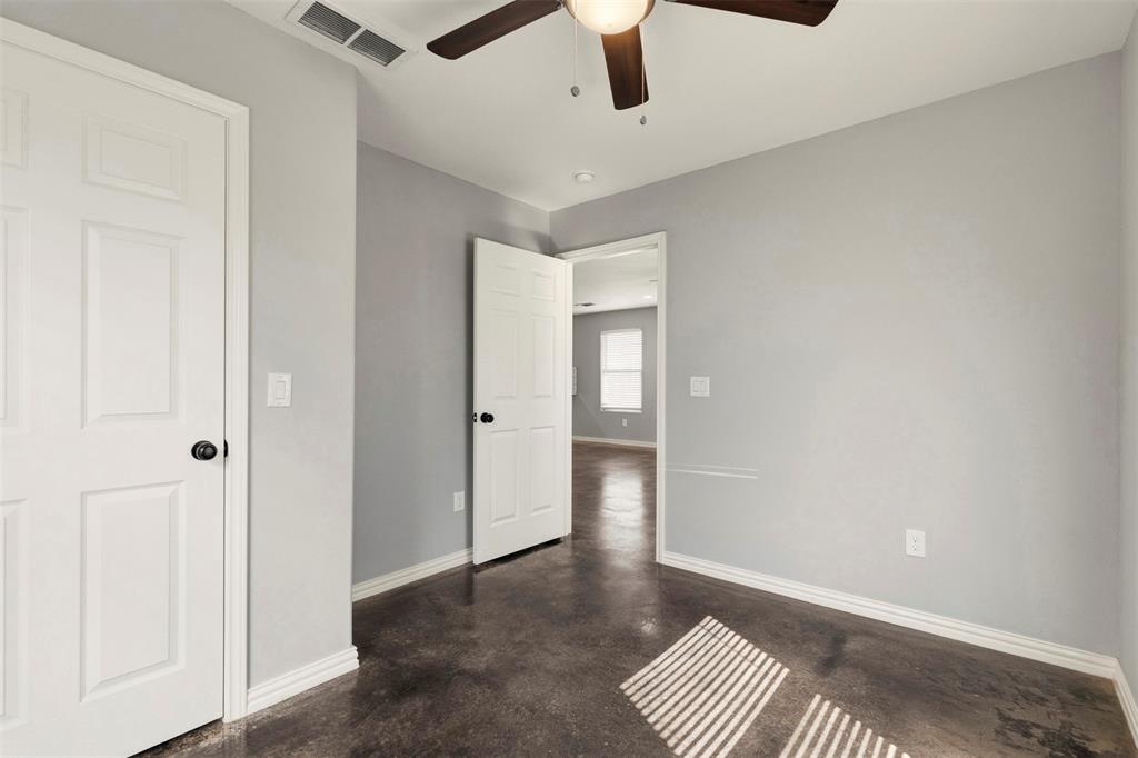 933 Rice Street Denison, TX 75020 - Photo 14 of 19 an empty room with a ceiling fan and wooden floor