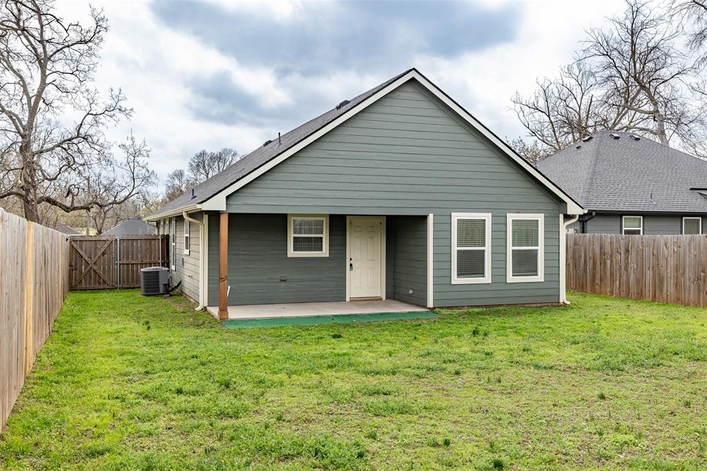 933 Rice Street Denison, TX 75020 - Photo 17 of 19 a front view of house with yard and green space