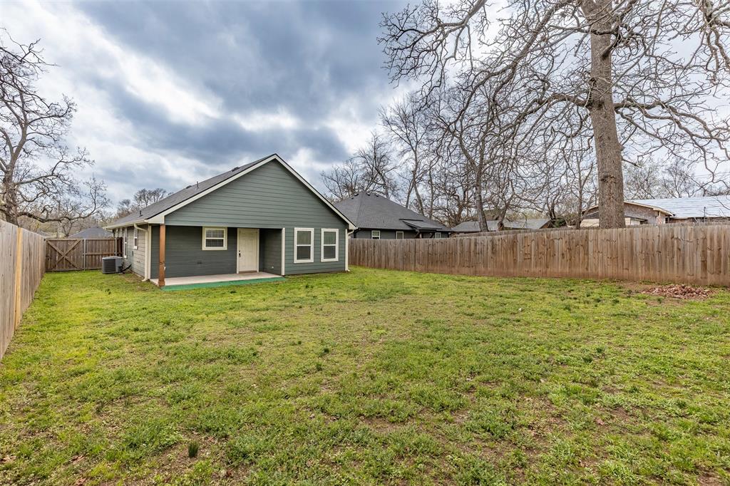 933 Rice Street Denison, TX 75020 - Photo 19 of 19 a front view of house with a garden