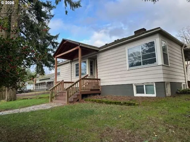a front view of a house with a garden