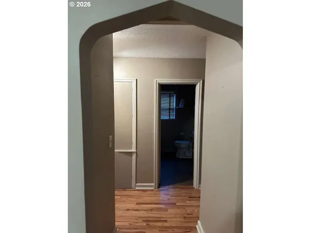 a view of hallway with wooden floor