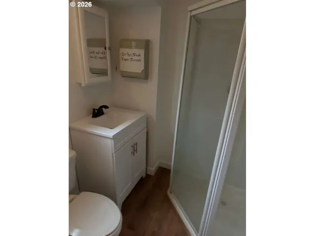 a white toilet sitting next to a sink