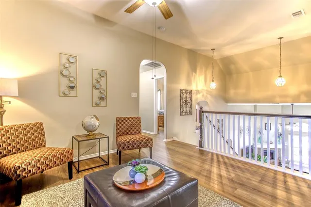 a living room with furniture and wooden floor