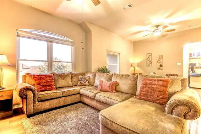 a living room with furniture and a large window